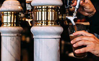 beer being poured from a beer tap