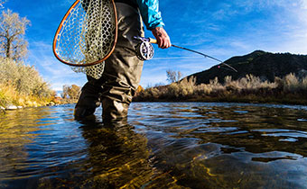 man fly fishing with net