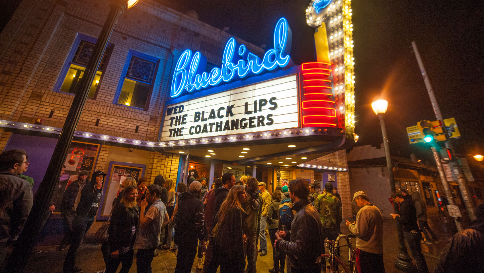 blue bird theatre with a crowd outside lined up 