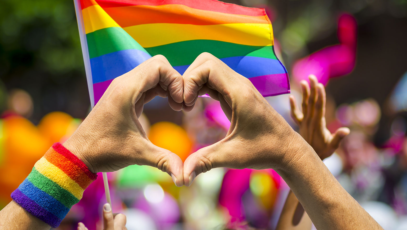 Hands making a heart at pride parade