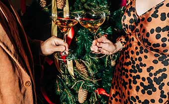 people with drinks at a holiday party