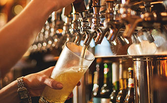 Beer taps with beer glass being filled