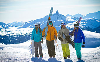 Happy skiers playing in snow